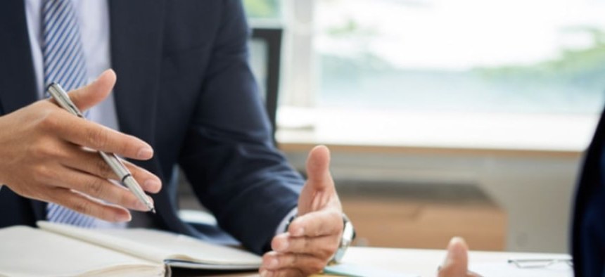 Advisor explaining a proposal across a desk