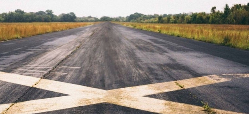 Runway stretching toward a tree line