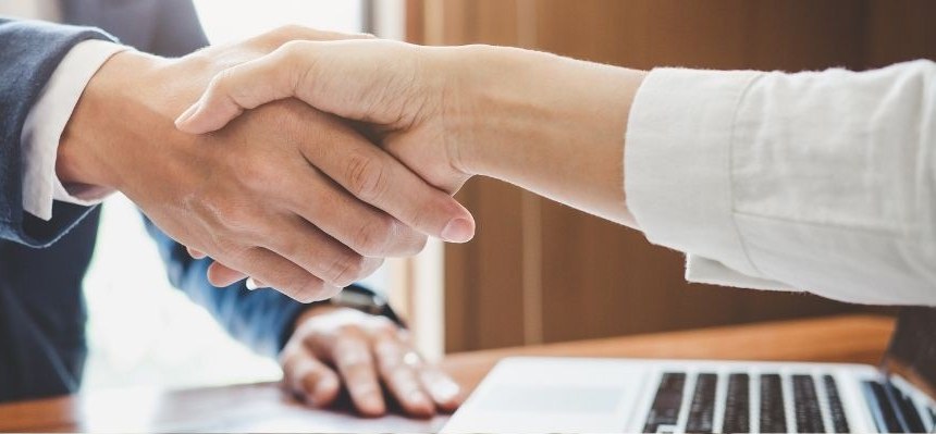 Business handshake across a desk