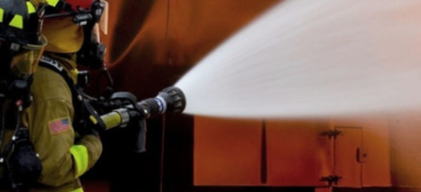 Firefighter directing a hose stream during a training exercise