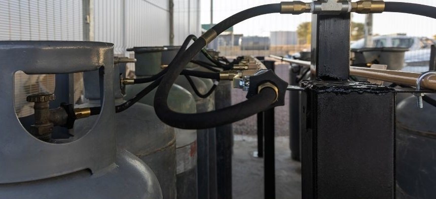 Propane cylinders connected to a manifold at a distribution site